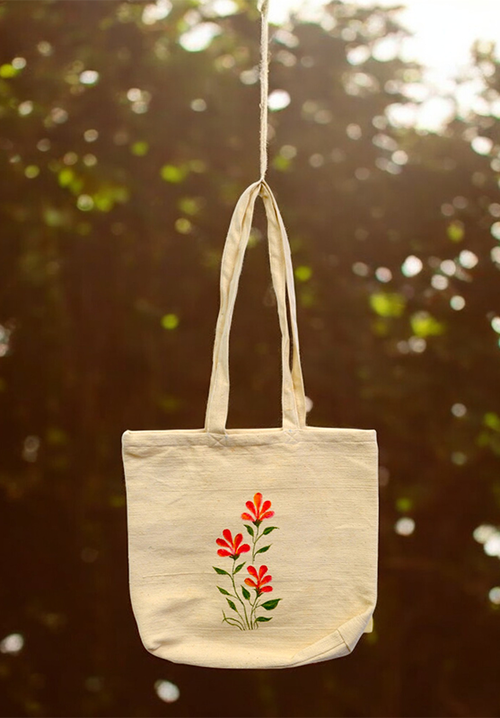 Eco-friendly hand-painted tote bag with floral design on natural cotton fabric