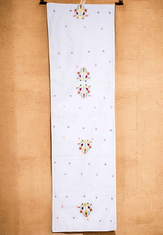 Close-up of traditional embroidery on Chamba Rumal table runner
